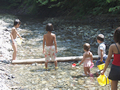 澄んだ水の流れに見とれる子どもたち